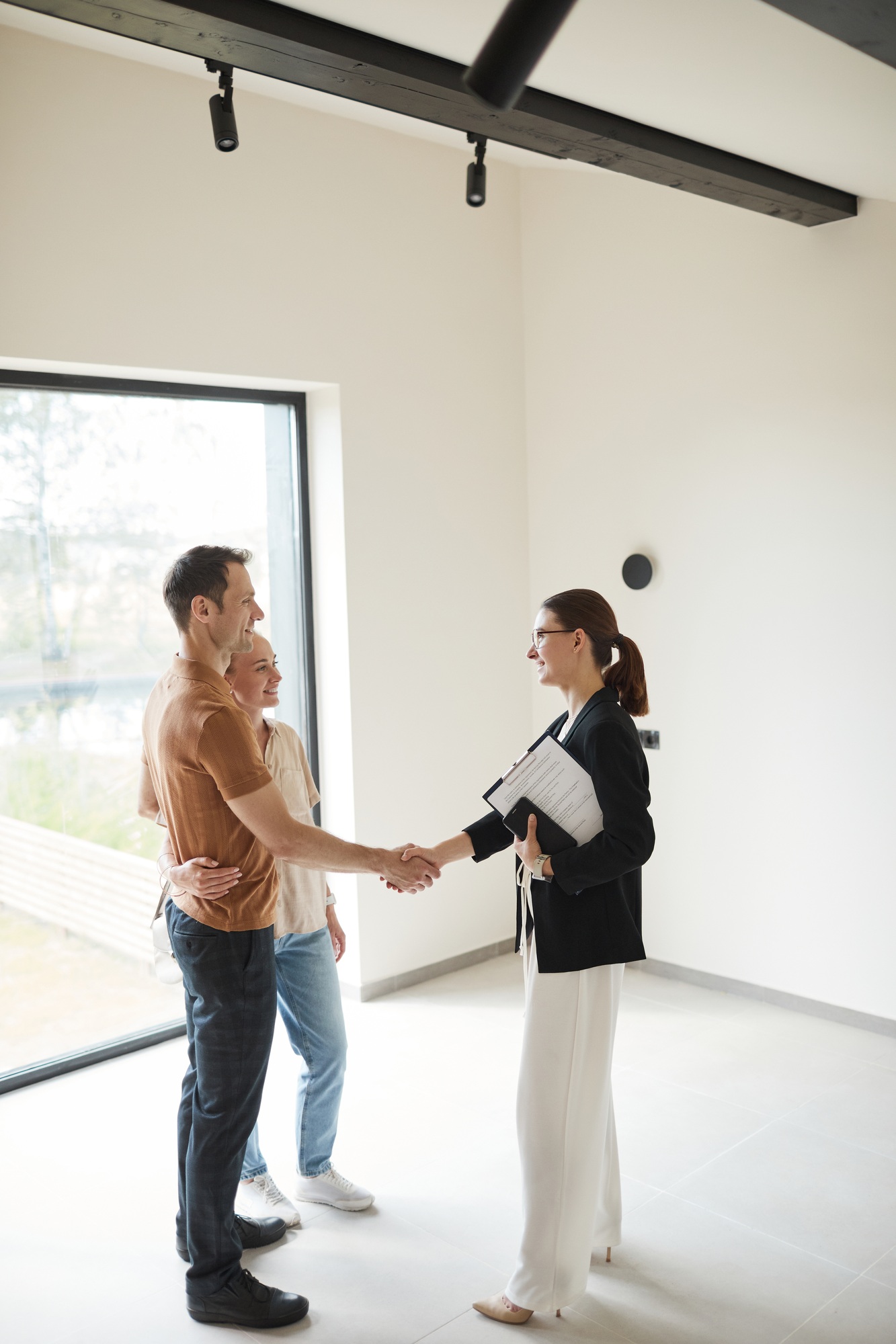 Couple Shaking Hands with Real Estate Agent
